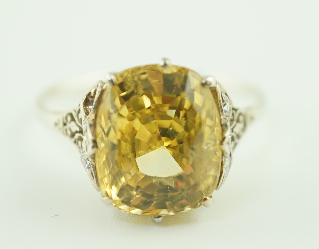 A mid 20th century platinum? and single stone fancy cushion cut yellow sapphire set dress ring with six stone diamond set pierced mount